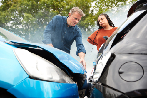 Charlotte rear-end car accident lawyer concept, car accident lawyer Panchenko law firm. Two people look on in shock at the result of a rear-end accident.