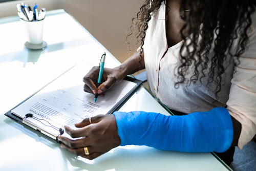 Fort Mill rideshare accident lawyer assisting injured woman filling out a claim form after a rideshare accident.
