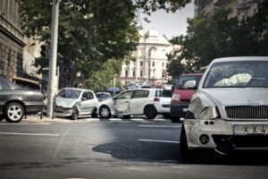 Car accident settlements are pursued after a multi-vehicle collision on a busy urban street intersection.