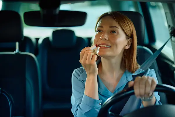 Woman Putting On Makeup In Car