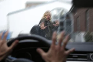 Woman struck by a car while using a pedestrian crosswalk, illustrating cases handled by a pedestrian accident lawyer at Panchenko Law Firm.
