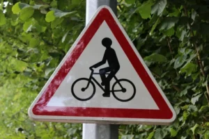 Bicycle crossing sign at an intersection, illustrating road safety issues handled by a bicycle accident lawyer.