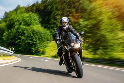 Motorcyclists driving around a turn